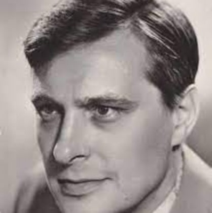  Oleg Valerianovich Basilashvili posing for a photo by wearing suit.